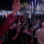 Stonewall Action Launch attendees raising their bricks